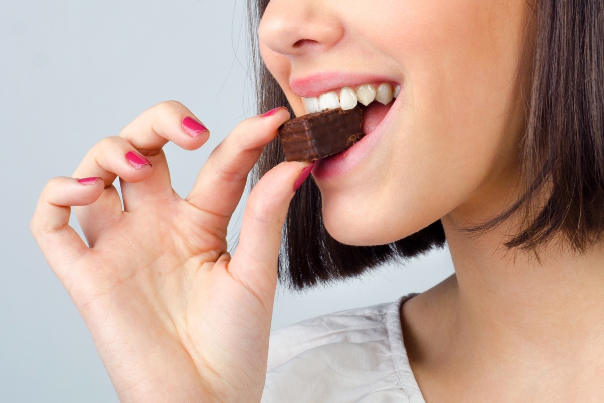 Woman eating piece of chocolate