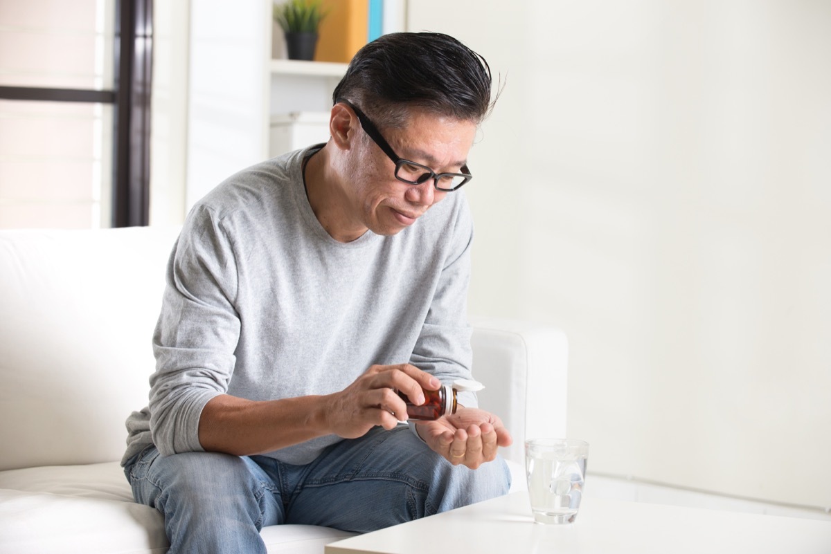 Man taking medication with water