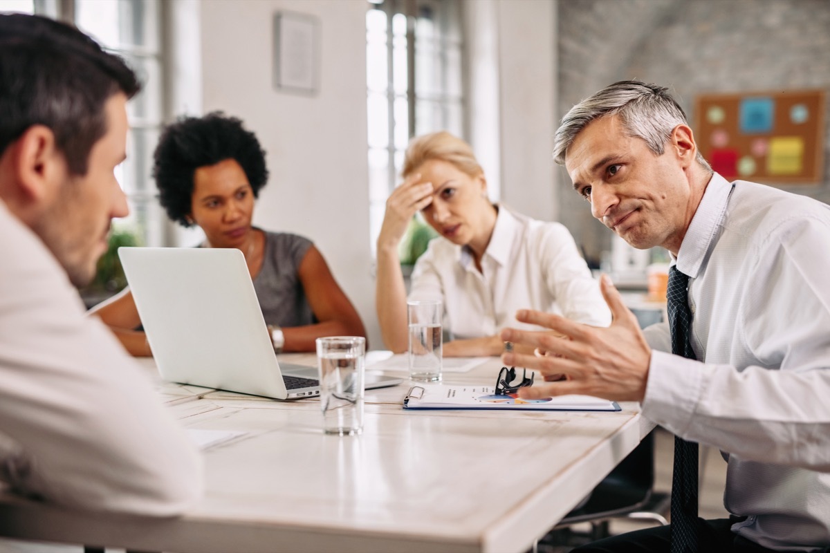 annoyed coworkers talking in a group