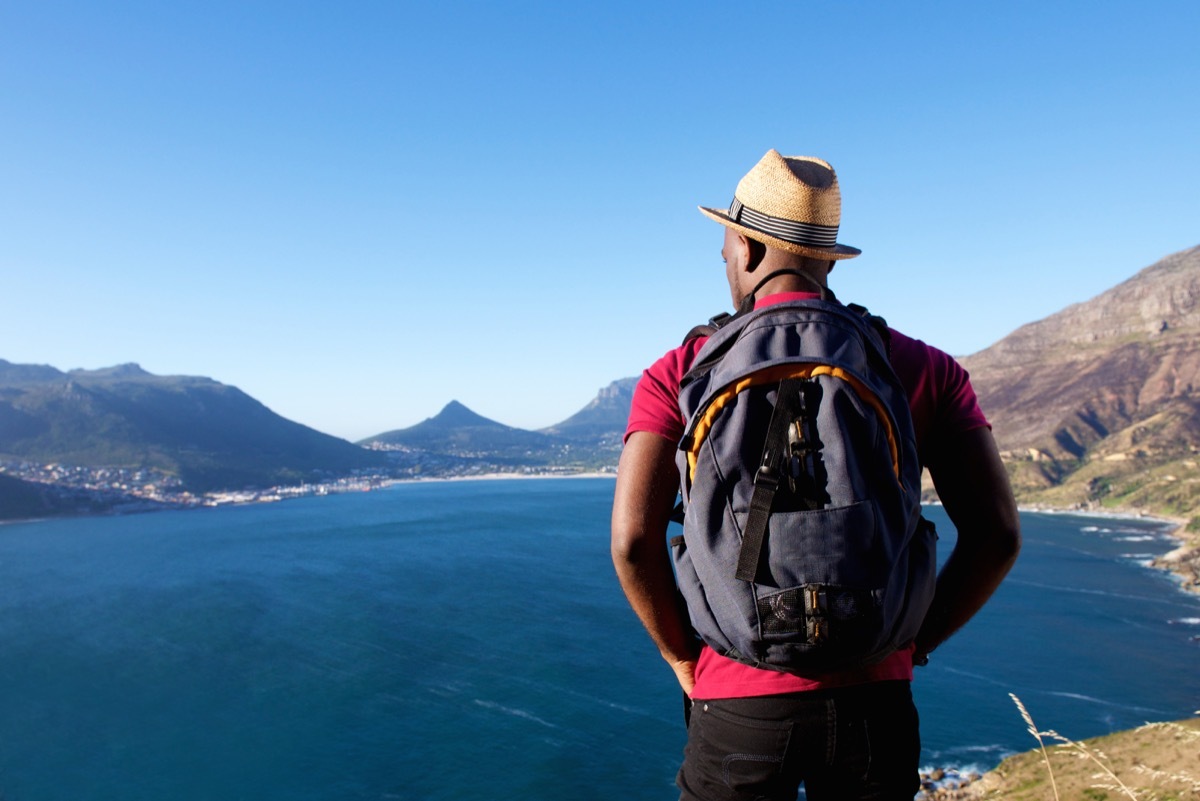 Man backpacking solo overlooking the water