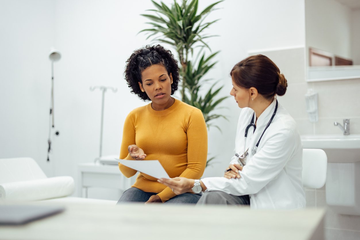 Patient consulting with doctor in office.