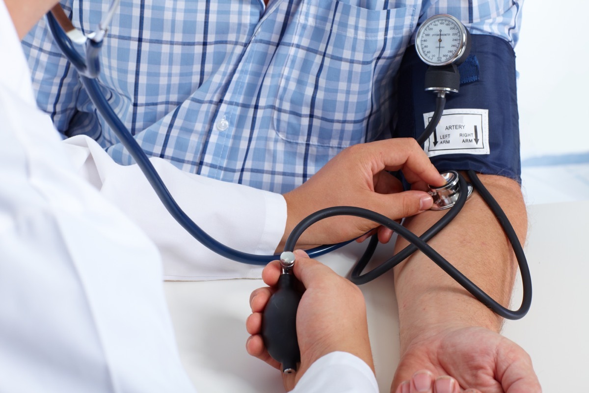 Doctor checking patient's blood pressure