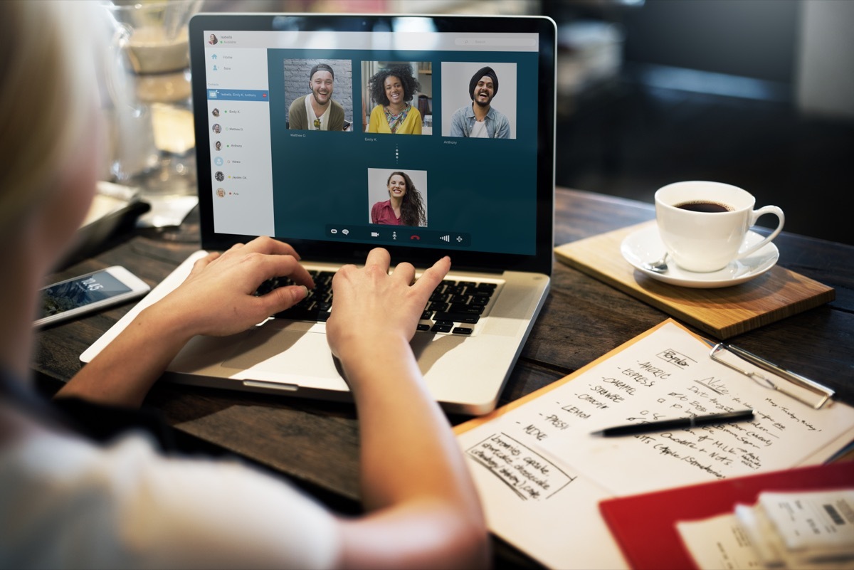 young white woman typing in chat function on video call while wfh