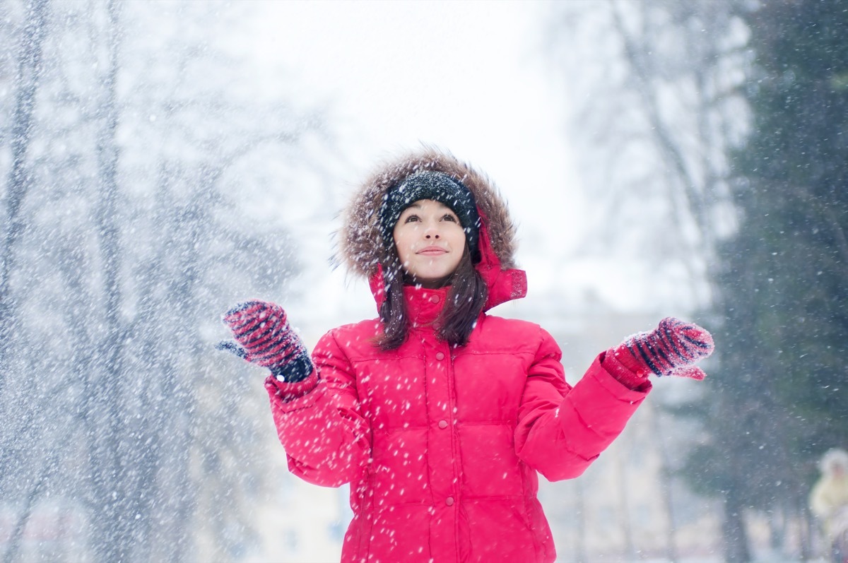 woman plays with a snow outdoor