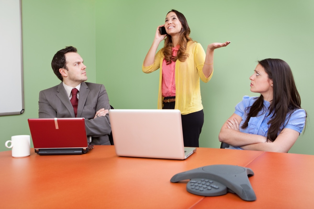 Woman on the Phone During a Meeting