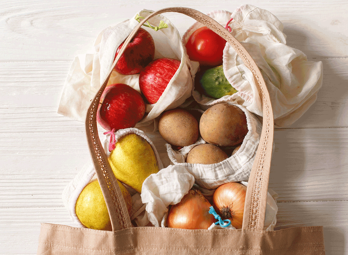 reusable grocery bag with fruits veggies spilling out