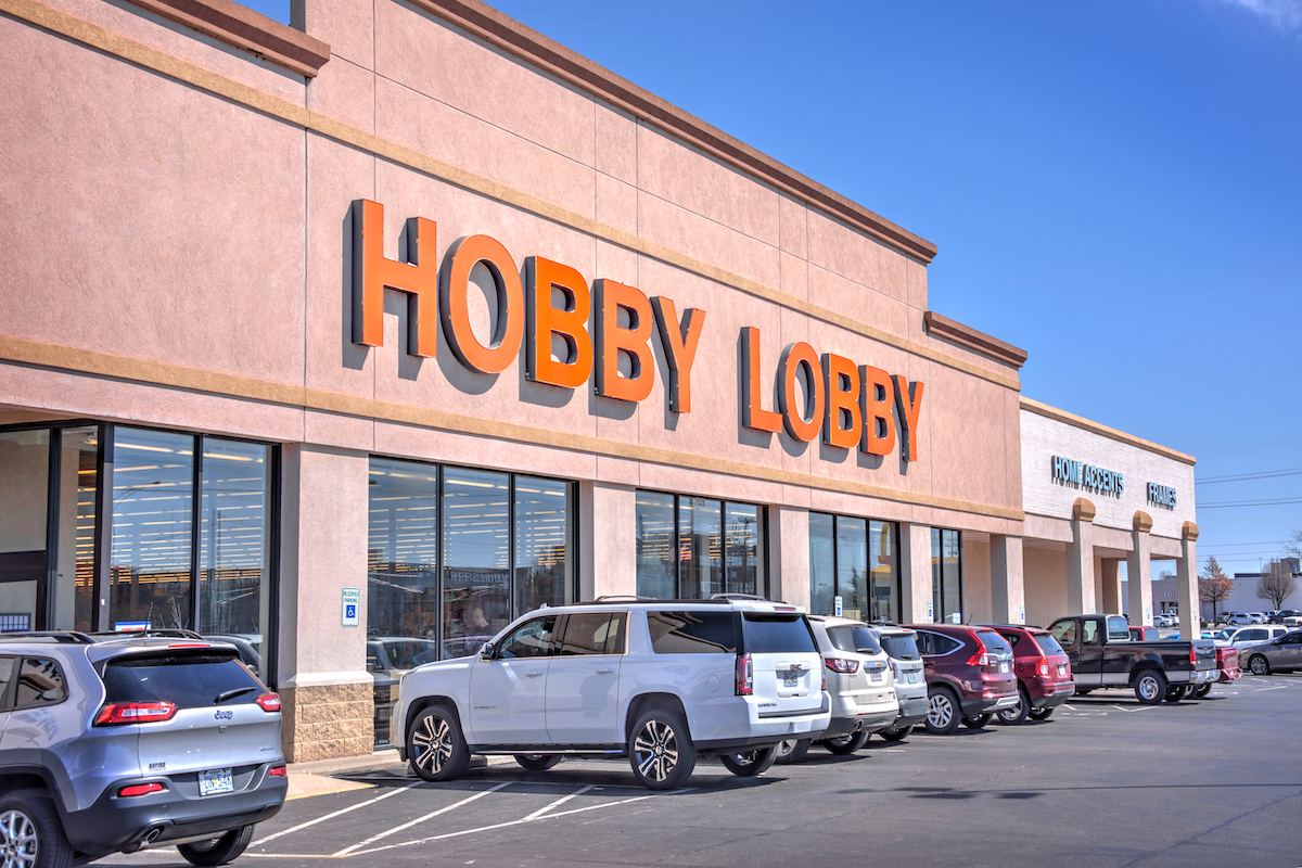 A view of a Hobby Lobby store with cars parked out front.