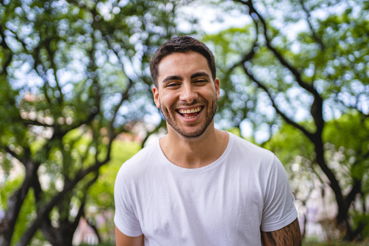 Portrait of a handsome man laughing and toothy smiling at the camera