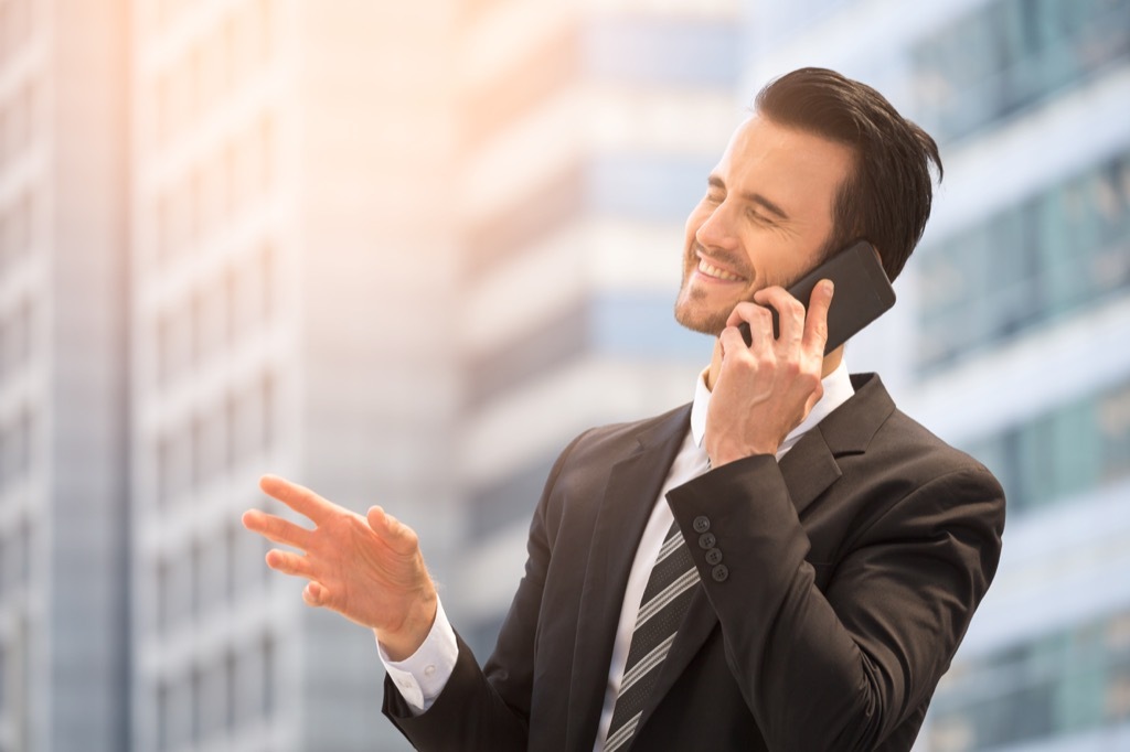 cheesy guy in suit on phone