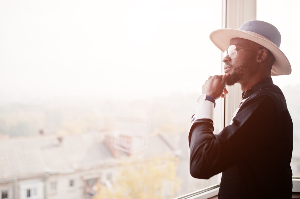 Man looking out window life changes after marriage