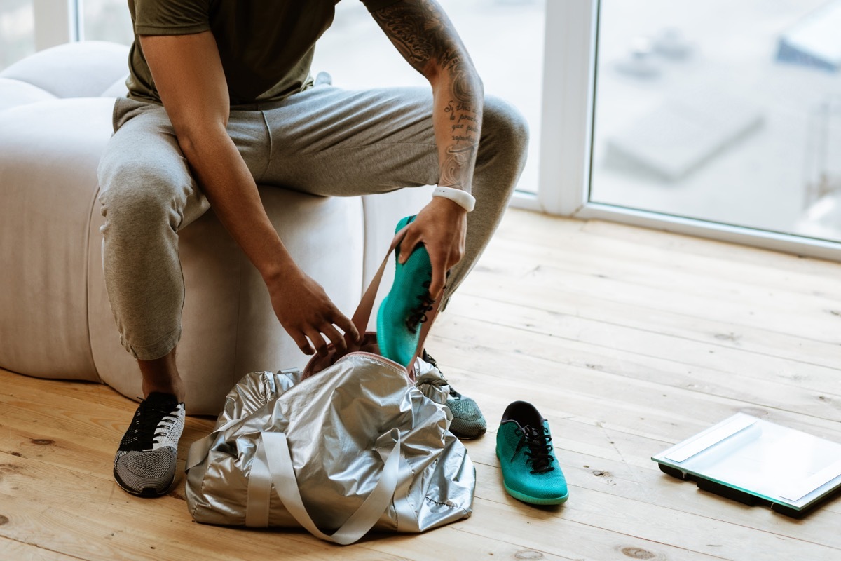 Man putting shoes away