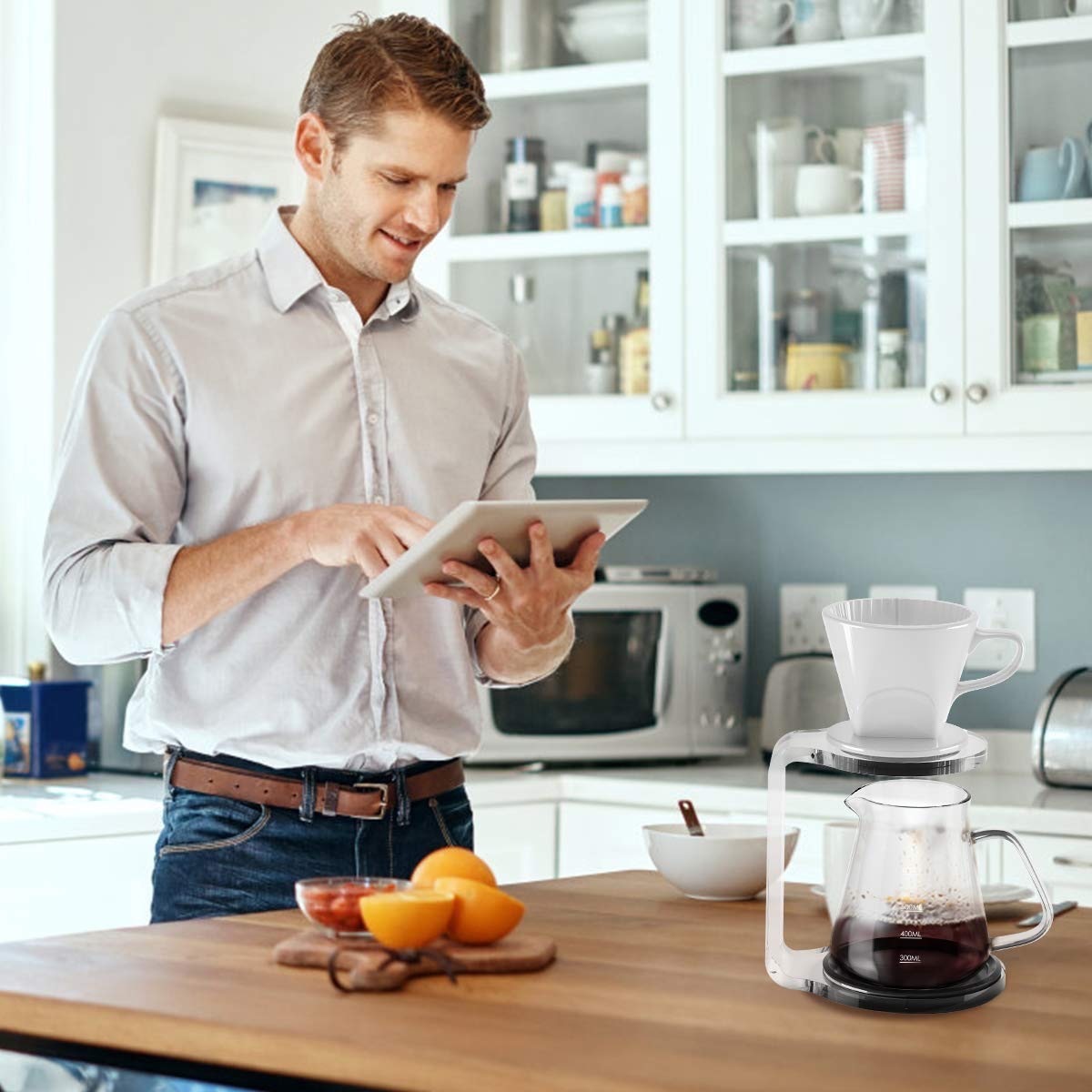 white man standing in kitchen next to coffee maker