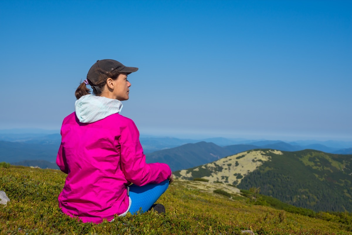 Person Contemplating on the Side of a Mountain