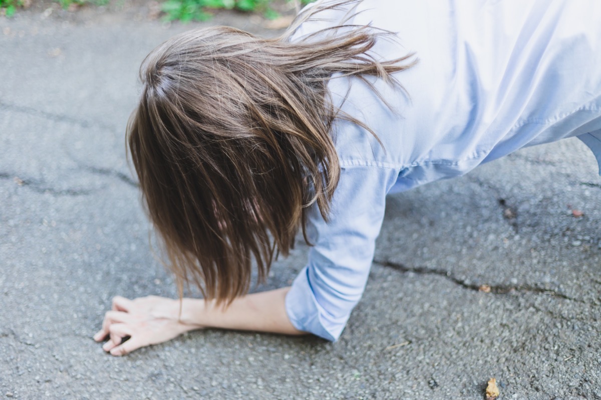 woman in blue shirt falling on ground