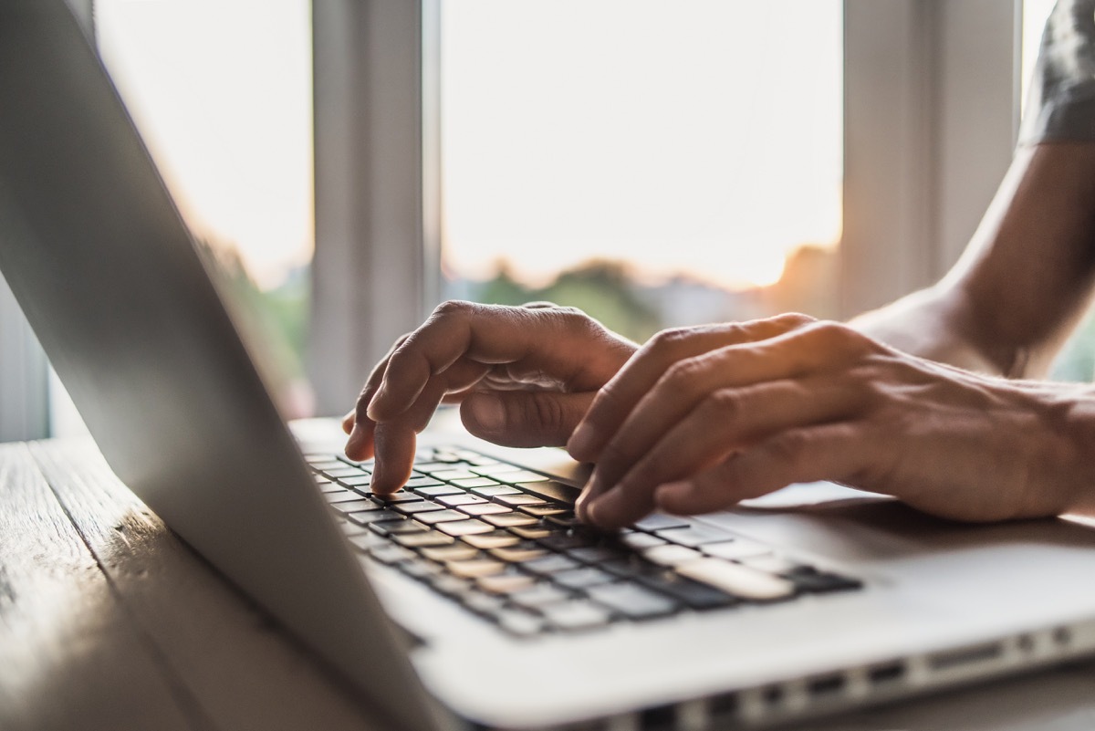 hands typing on a laptop