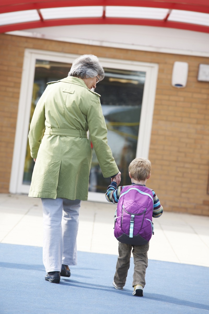 Grandma walking grandson to school