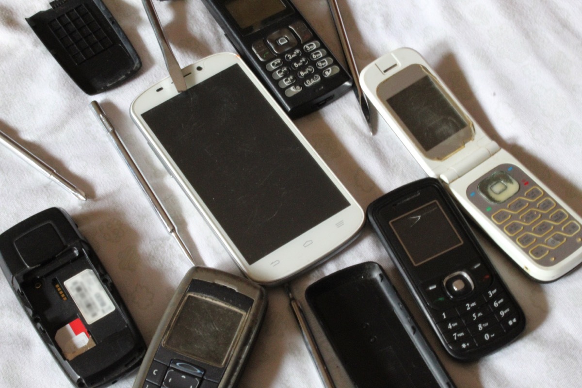 Old mobile phones all together being serviced or repaired.