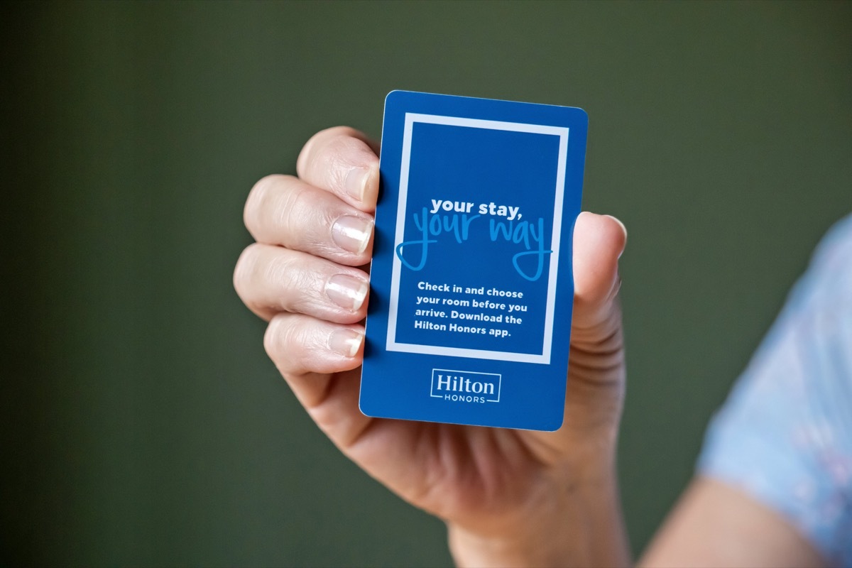 BEMIDJI, MN - 20 JUL 2020: Womans hand holding room security keycard for Hilton Hotels in close-up view. Advertising for Hilton Honors with the words your stay, your way written on front of card.