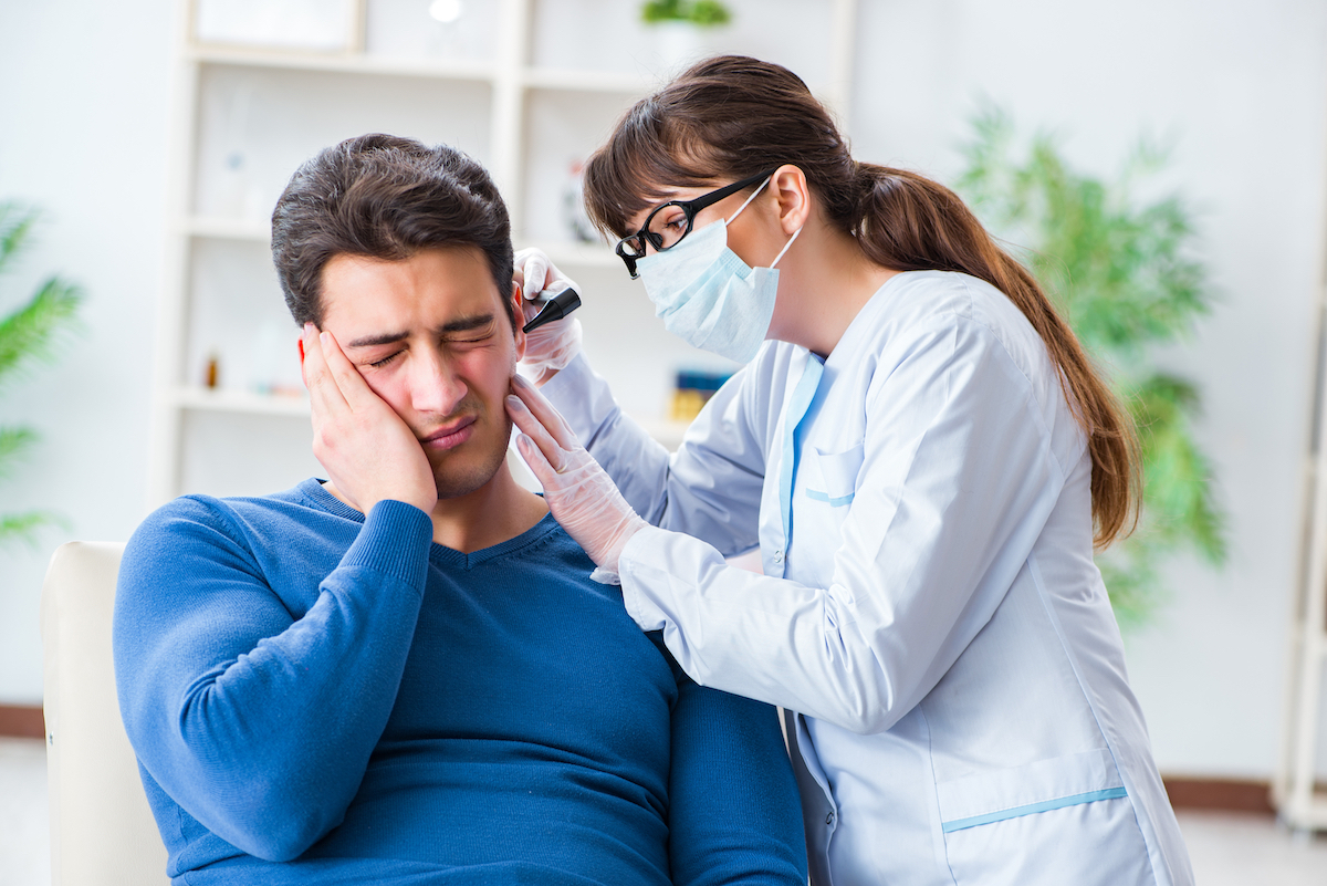 Doctor looking at patient's ear