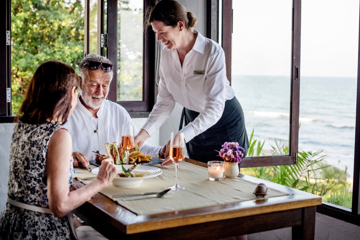 mature couple dining at a beach resort restaurant