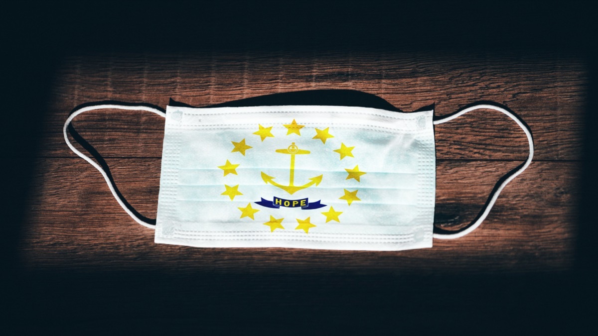 Rhode Island Flag. Coronavirus Covid 19 in U.S. State. Medical mask