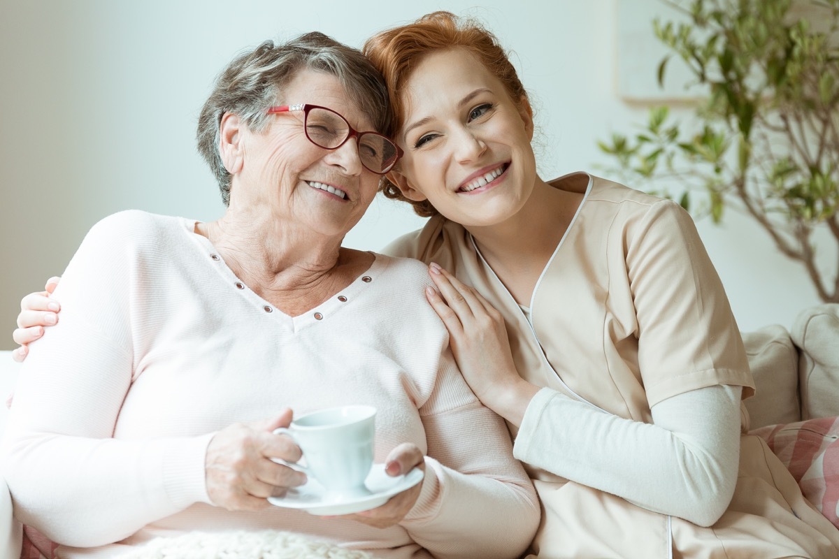 mom and daughter hugging and smiling on couch