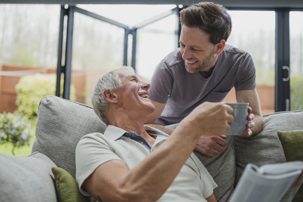 Son giving father a cup of coffee kindly