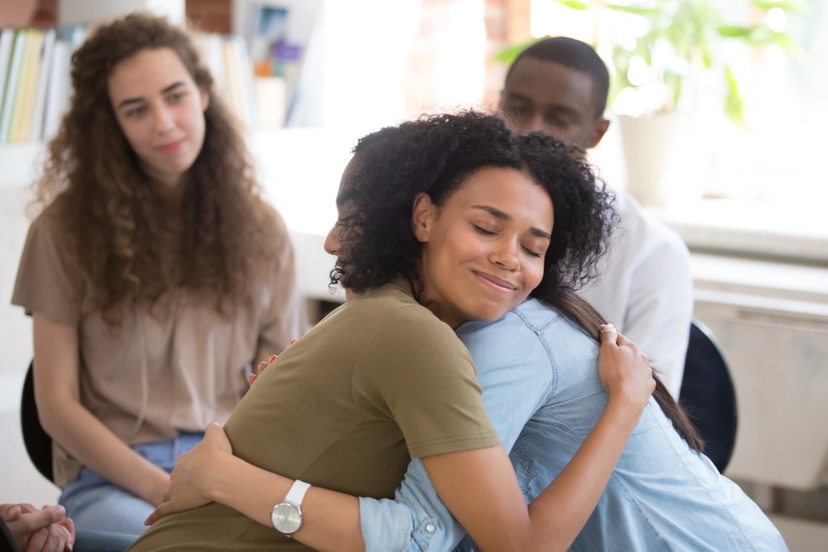 Women embracing at meeting