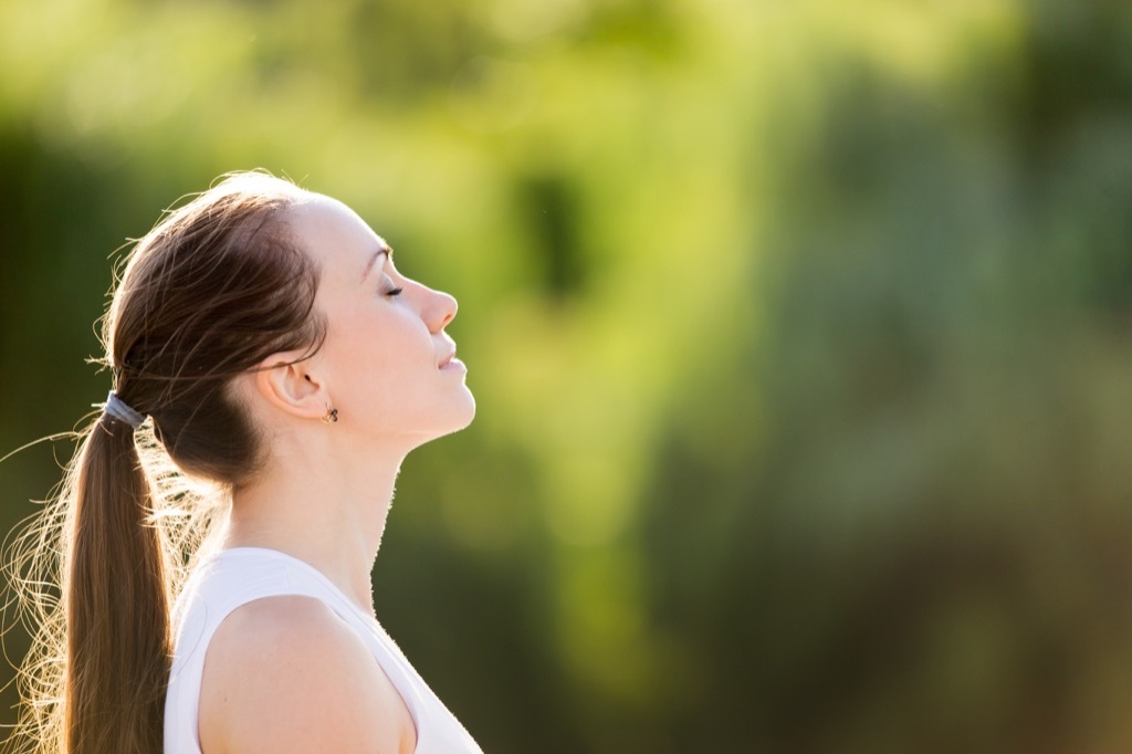 Woman is calm in the outdoors.