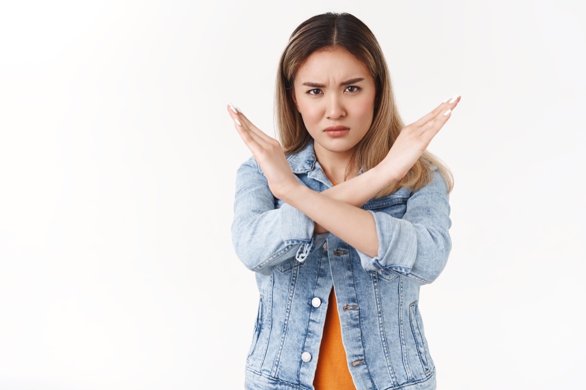 Displeased serious-looking assertive intense disagree asian blond girl making cross arms frowning disappointed