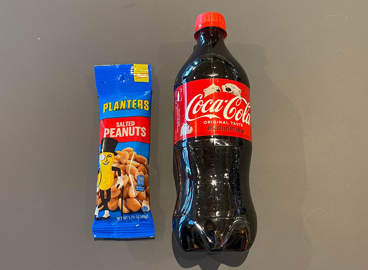 bottle of coke and packet of peanuts