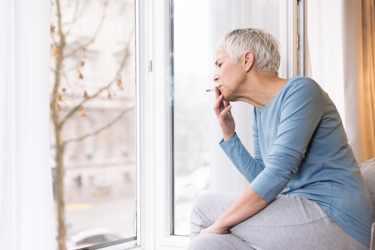 Older woman smoking unhealthy