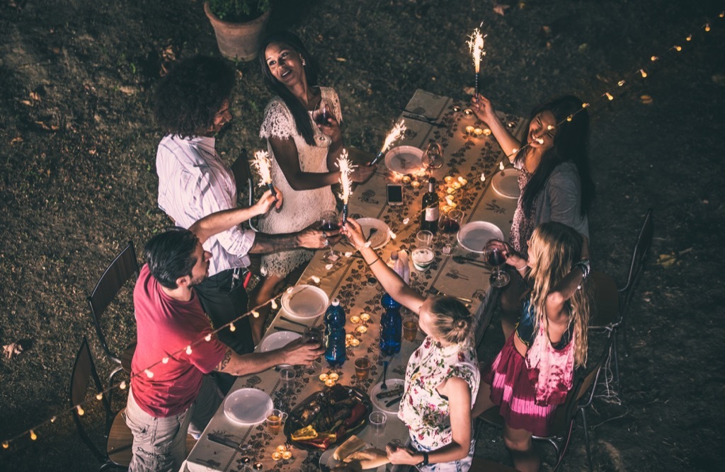 young people partying around a picnic table