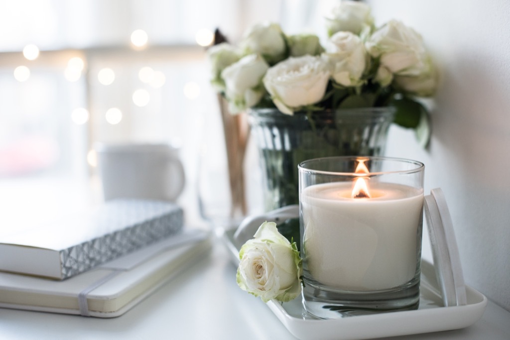 Candle burning at a desk