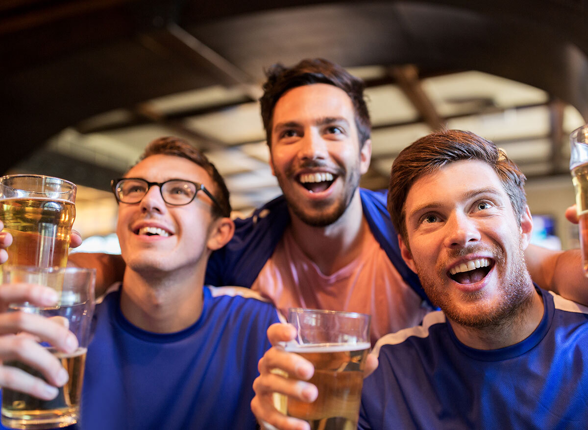 men drinking beer at a bar