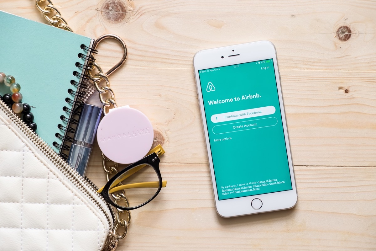 airbnb app on phone next to wallet