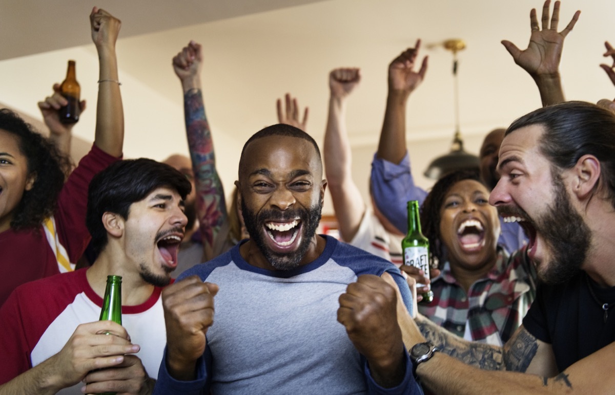 Friends cheering sport at bar together