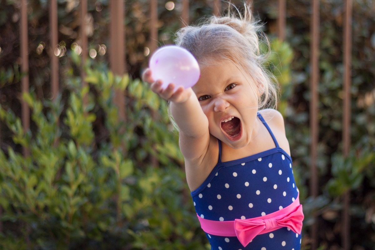 Little girl preparing for a water balloon fight