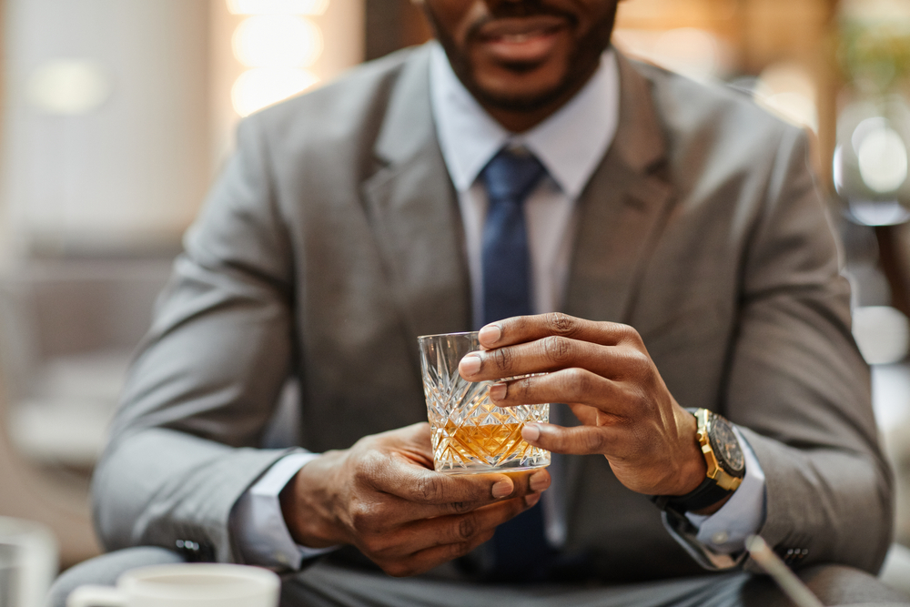 Handsome, successful businessman in suit with cocktail