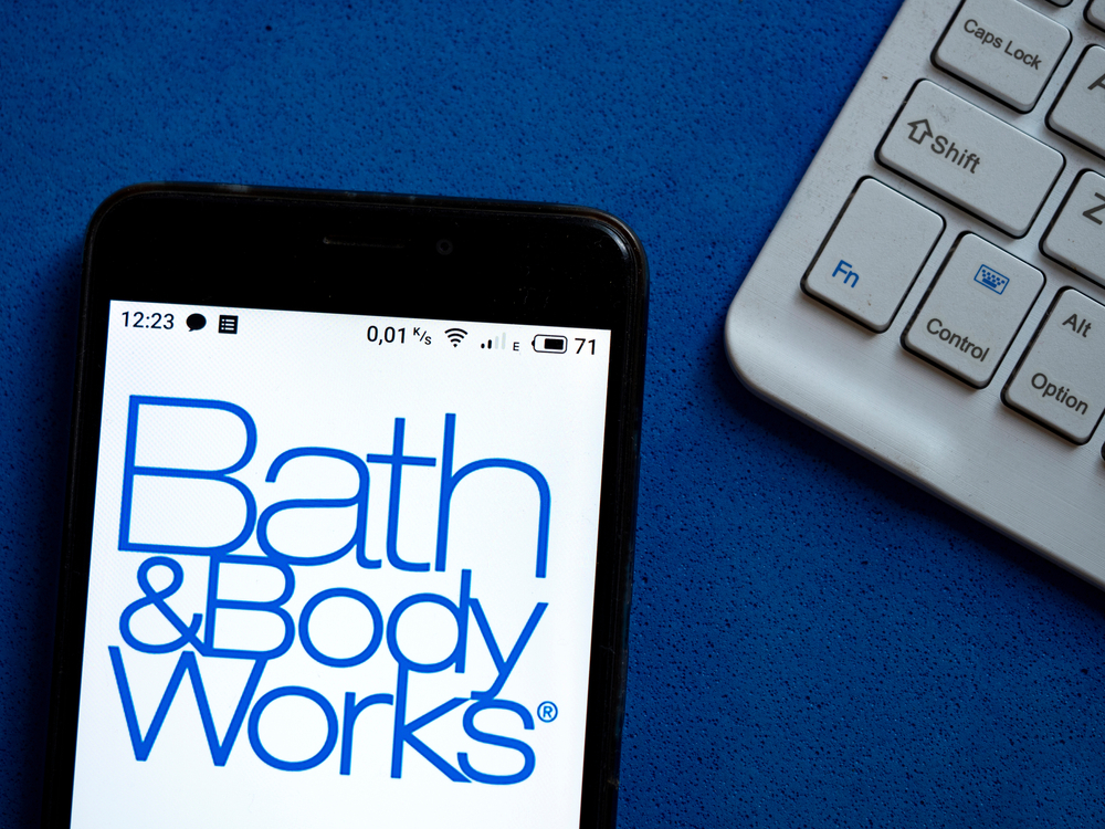 A phone next to a keyboard with the Bath & Body Works logo displayed on the screen