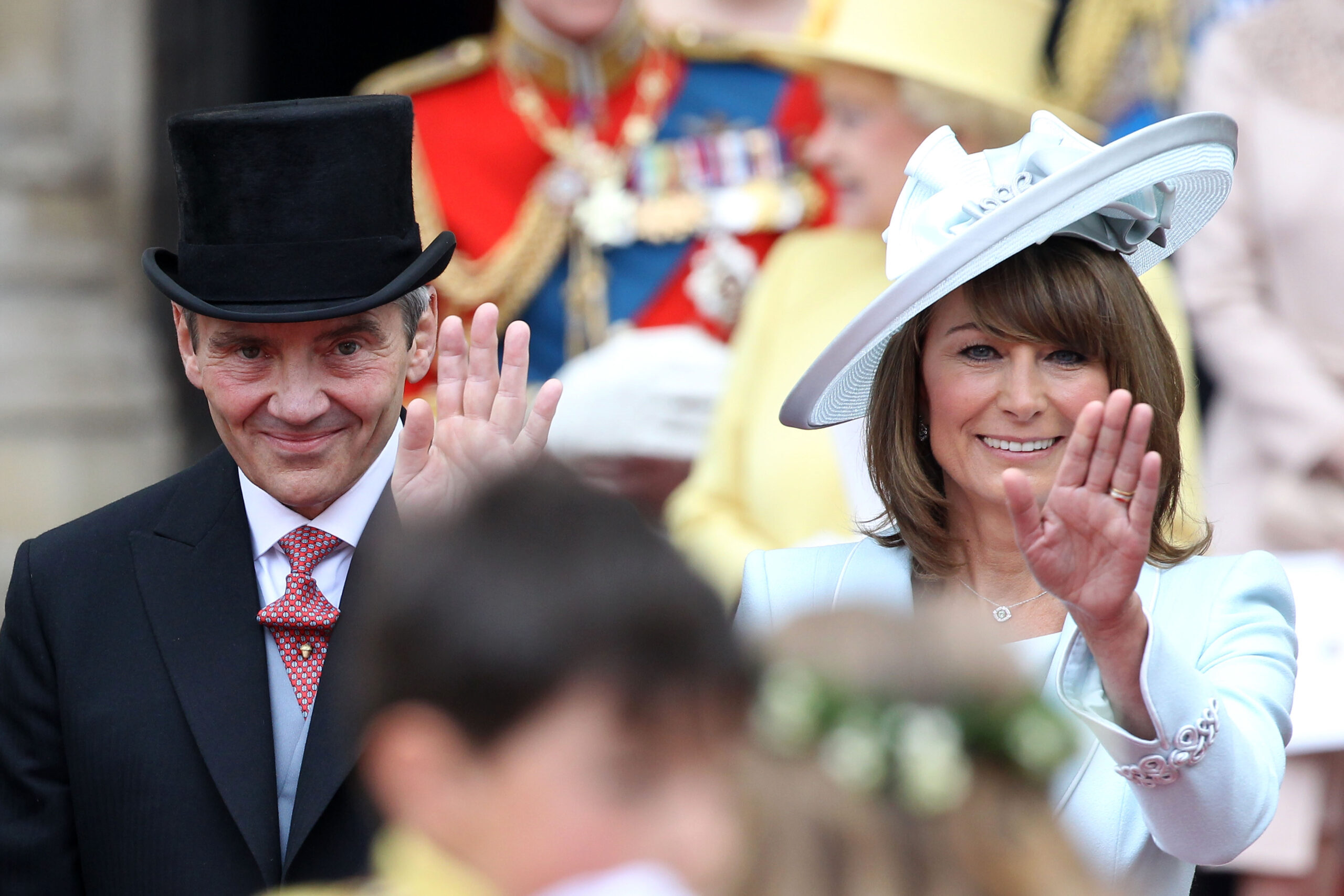 Michael and Carole Middleton smile and wave at the crowds following the marriage of Prince William, Duke of Cambridge and Catherine, Duchess of Cambridge at Westminster Abbey on April 29, 2011 in London, England.