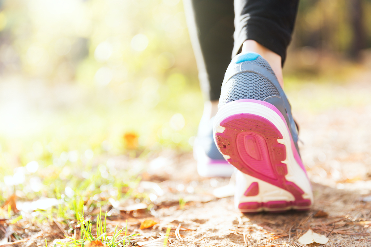 Woman running legs in sunrise orest