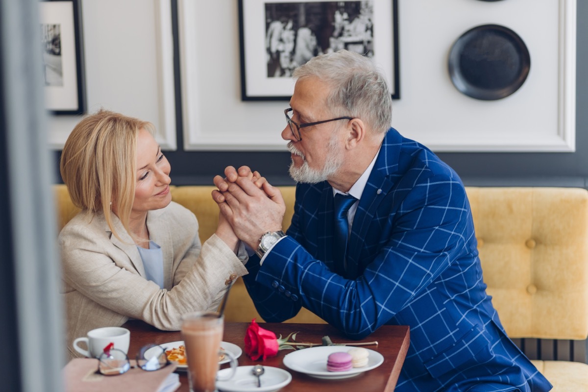 Older man complimenting woman on romantic date