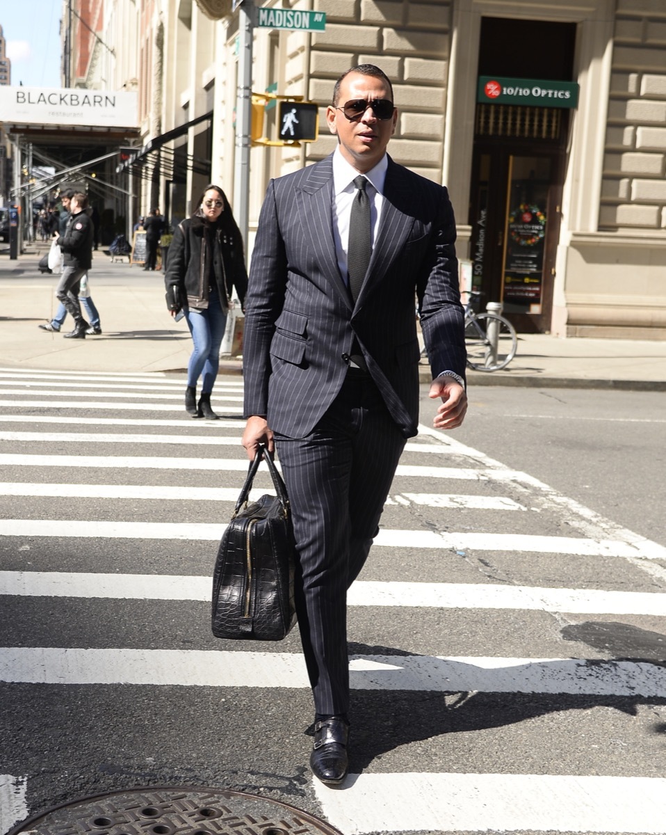 alex rodriguez in pinstripe suit walking on new york city street