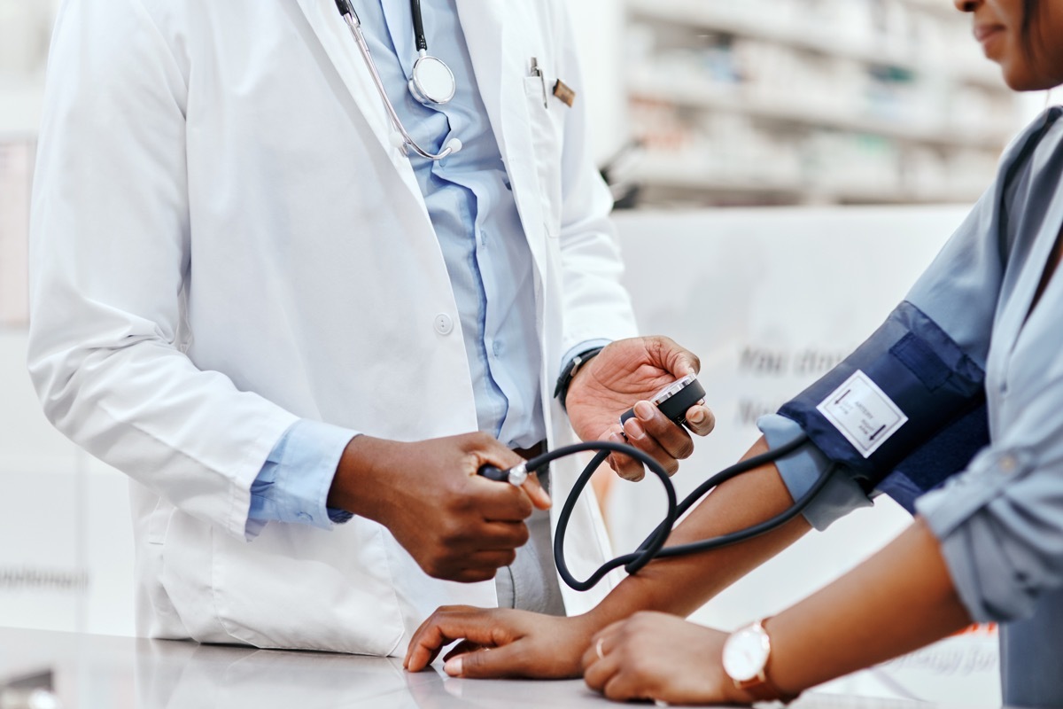 Closeup shot of an unrecognizable pharmacist taking a patient's blood pressure in a chemist