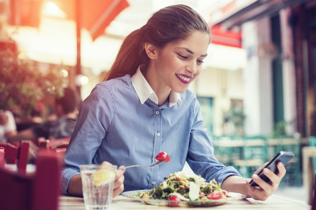 Woman Eating a Salad on the Phone Social Media