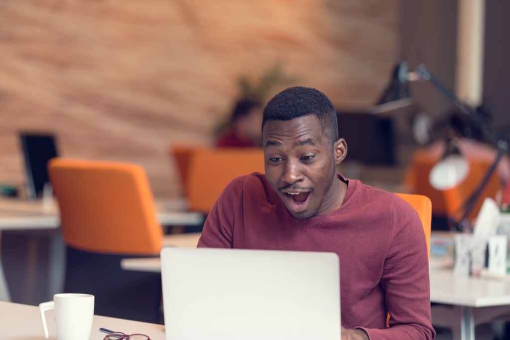 man looking astonished at a laptop