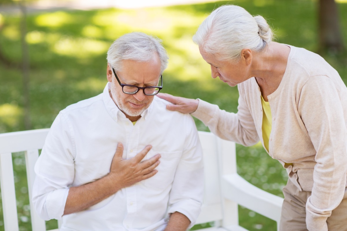 Man holding heart while wife helps