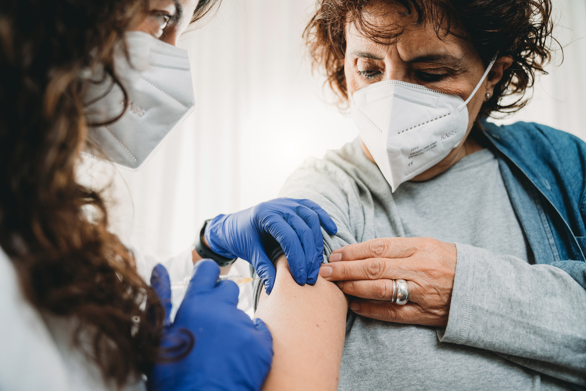 A female doctor is vaccinating a lady against Covid-19