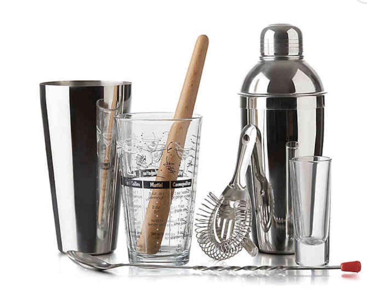 cocktail set with wooden muddler, silver cup, and silver shaker